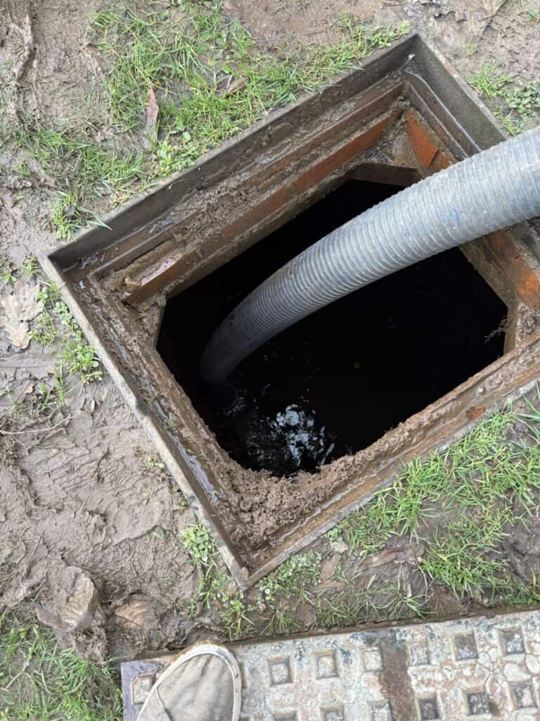 Drainage soakaway with flexible pipe for effective water management.